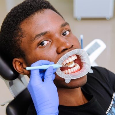 african-male-patient-getting-dental-treatment-dental-clinic_105818-127